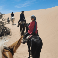 Horse riders in the Moroccan desert.